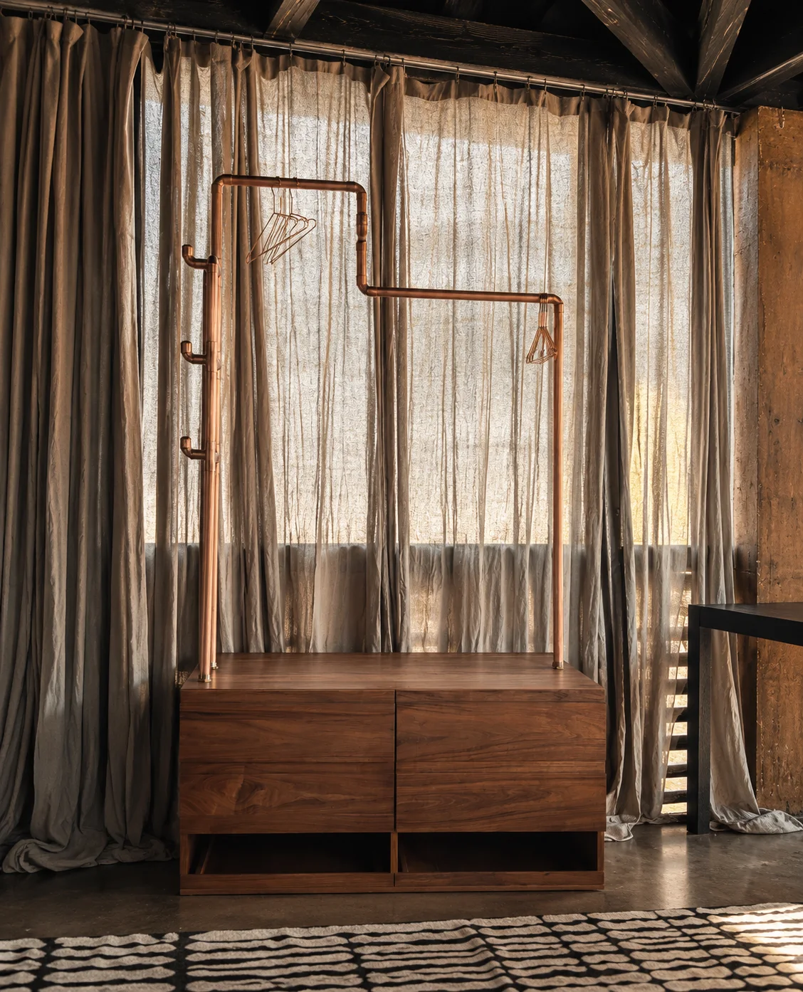 Casa Silencio: Editorial scene based on the original photos · mobile wood-and-copper closet.